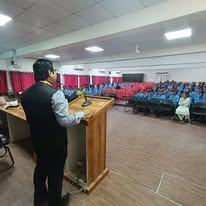 Addressing students from the podium