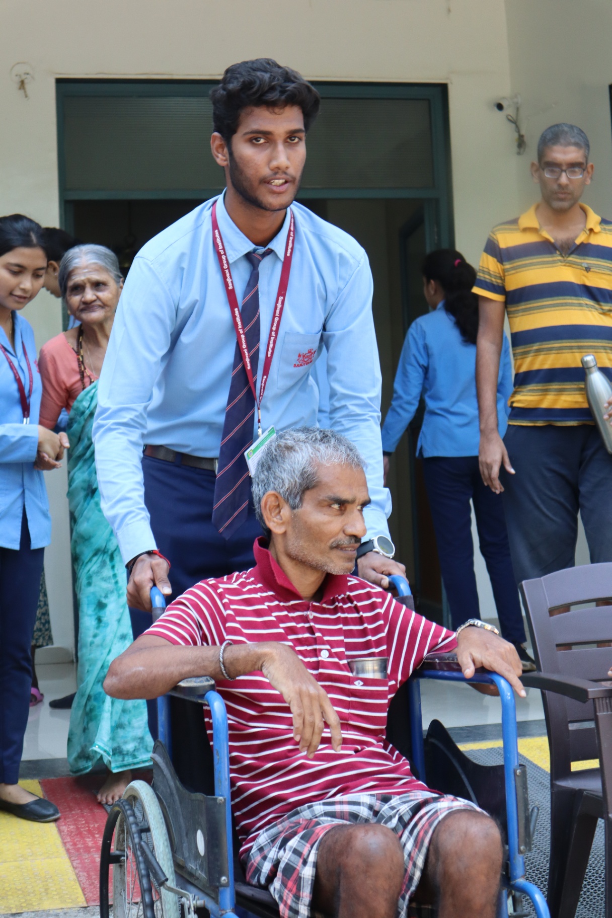 Student assisting a resident in a wheelchair